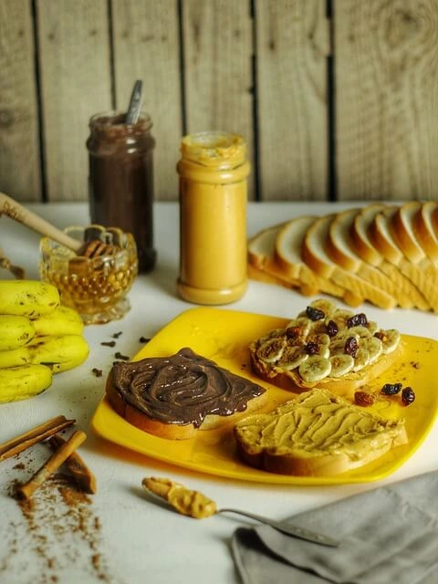 Slices of bread with various spreads, bananas, and honey, ingredients for a banana bread recipe without butter.